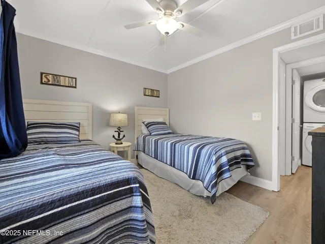 a bedroom with double bed and a chandelier