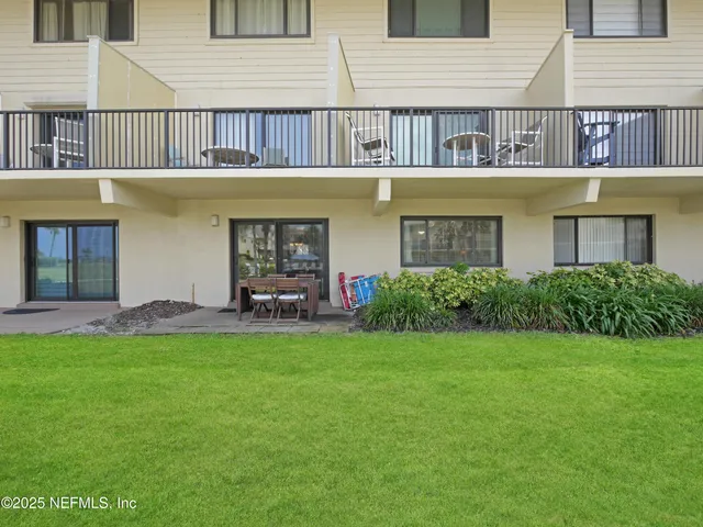 a view of a building with a yard and plants