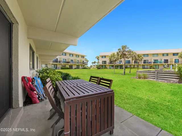 a view of a patio with a table and chairs