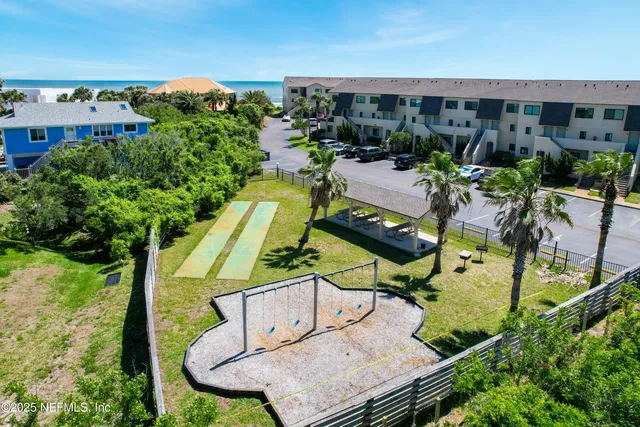 an aerial view of a house with swimming pool and patio