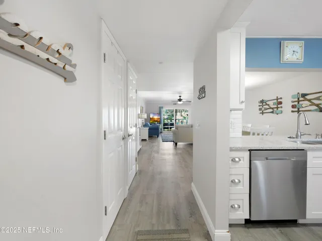 a view of a hallway view with furniture and wooden floor