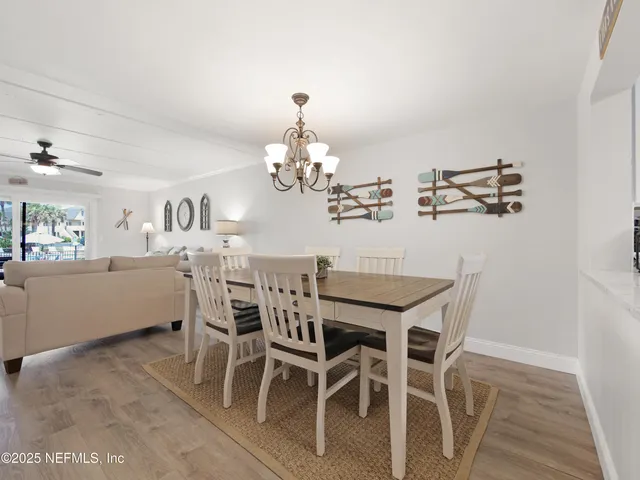 a view of a dining room with furniture and chandelier