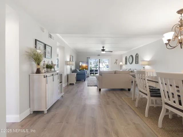 a living room with furniture and a kitchen view