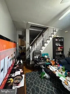 a view of a room with lots of stuff and hardwood floor