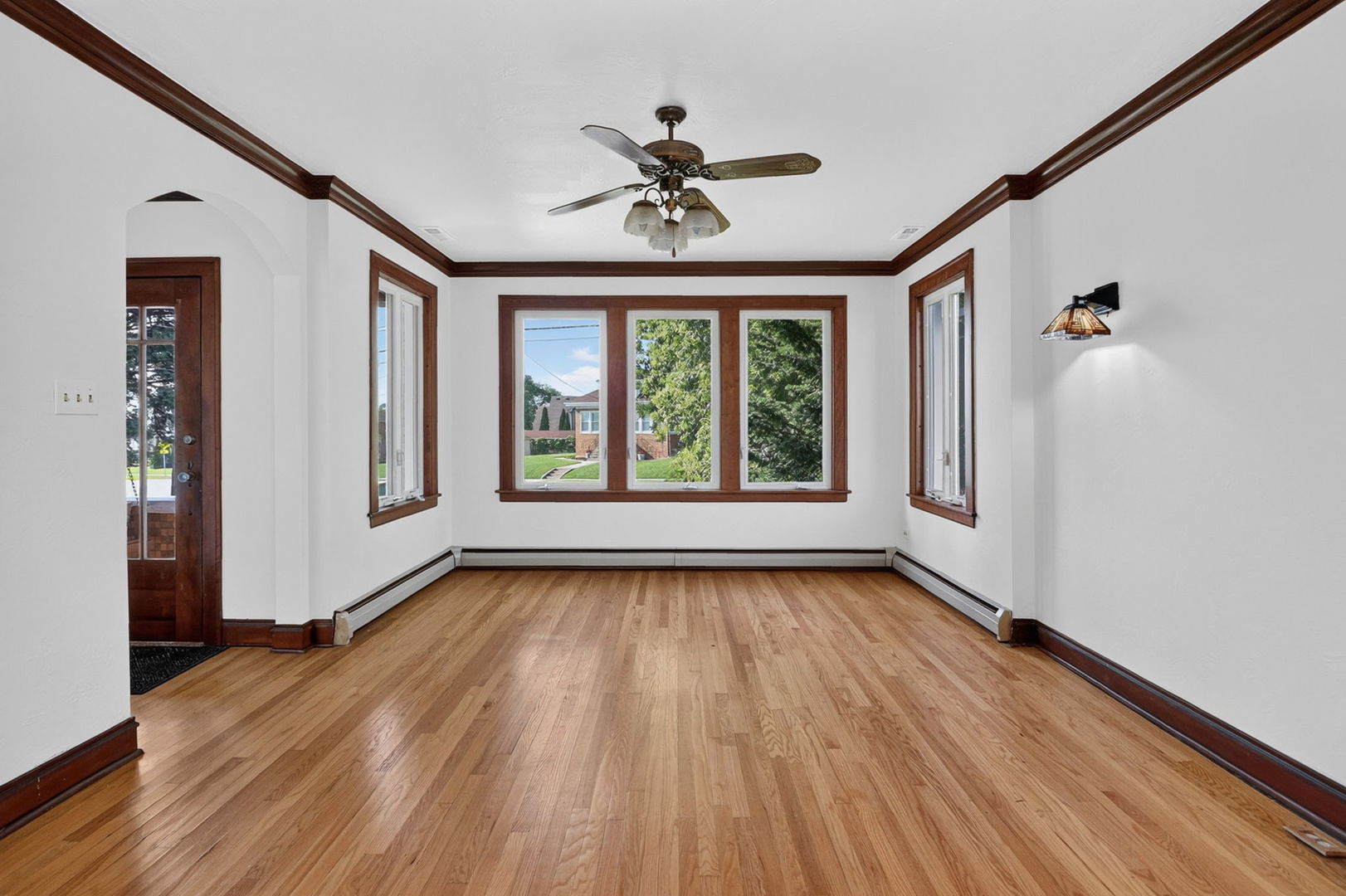 708 McCarthy Road Lemont, IL 60439 - Photo 2 of 14 wooden floor in an empty room with a window
