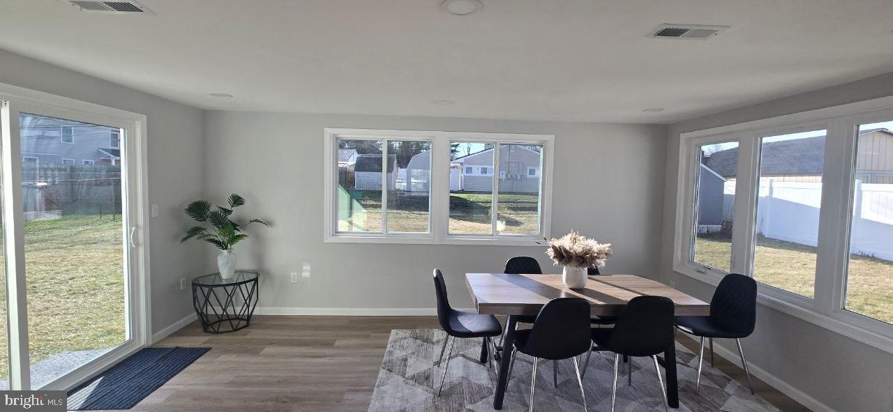 35 Beechtree Road Levittown, PA 19057 - Photo 8 of 20 a dining room with furniture a chandelier and wooden floor