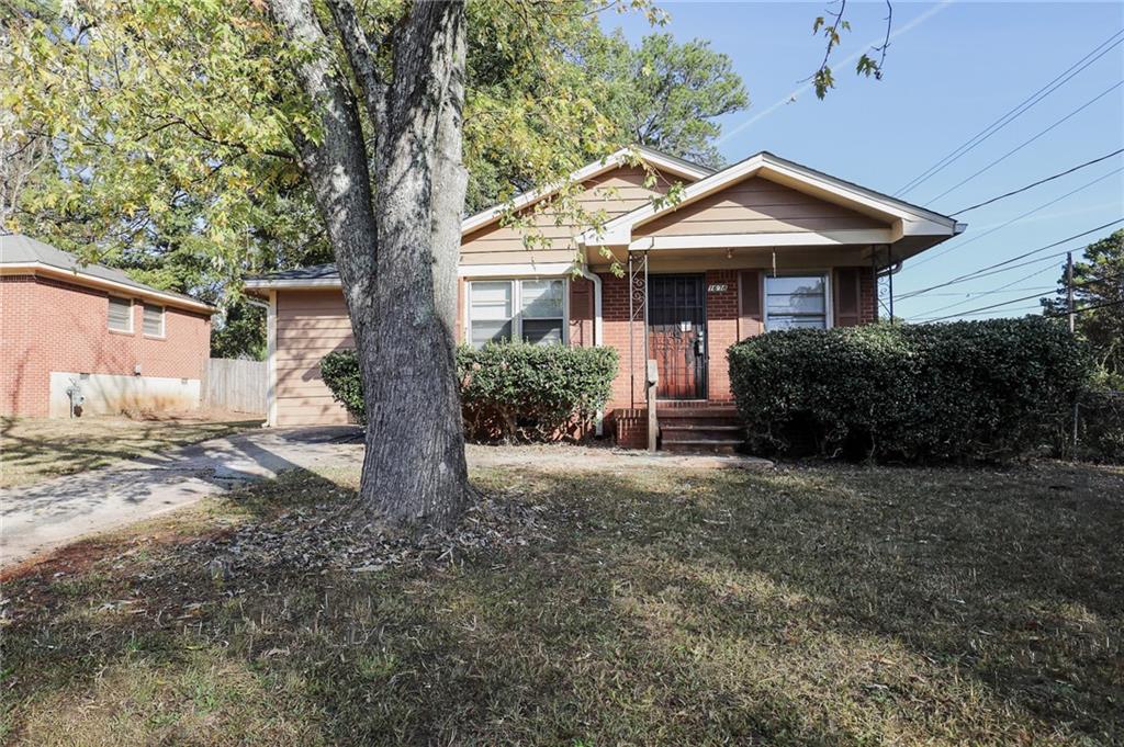 1678 Bagpipe Place Conley, GA 30288 - Photo 1 of 16 a front view of a house with a garden