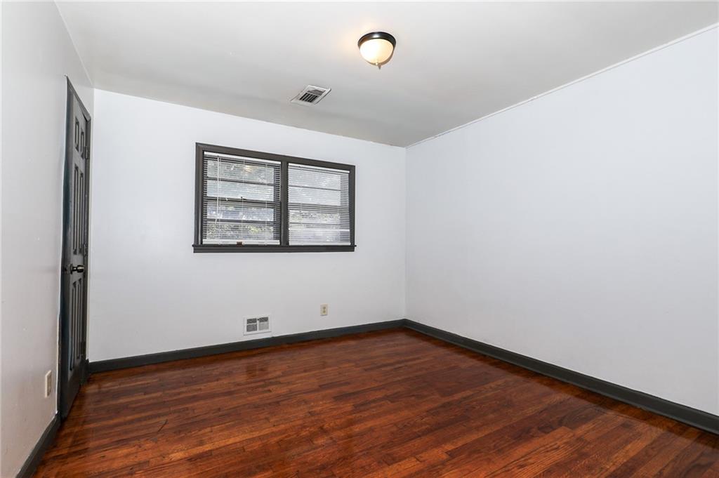 1678 Bagpipe Place Conley, GA 30288 - Photo 11 of 16 an empty room with wooden floor and windows