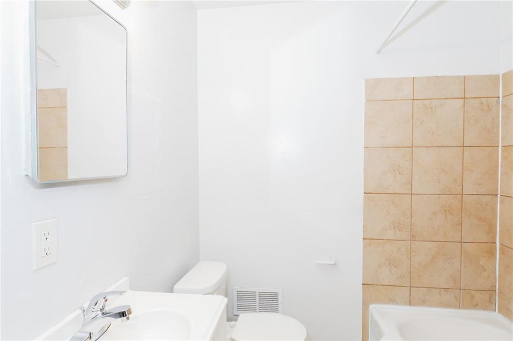 1678 Bagpipe Place Conley, GA 30288 - Photo 14 of 16 a bathroom with a toilet and sink