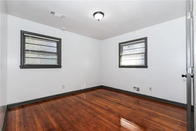 a view of a room with wooden floor and window