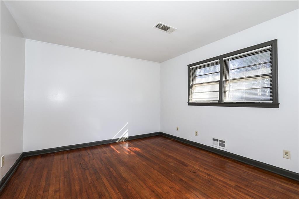1678 Bagpipe Place Conley, GA 30288 - Photo 5 of 16 an empty room with wooden floor and windows
