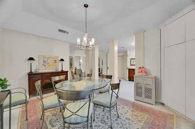a view of a dining room with furniture and chandelier
