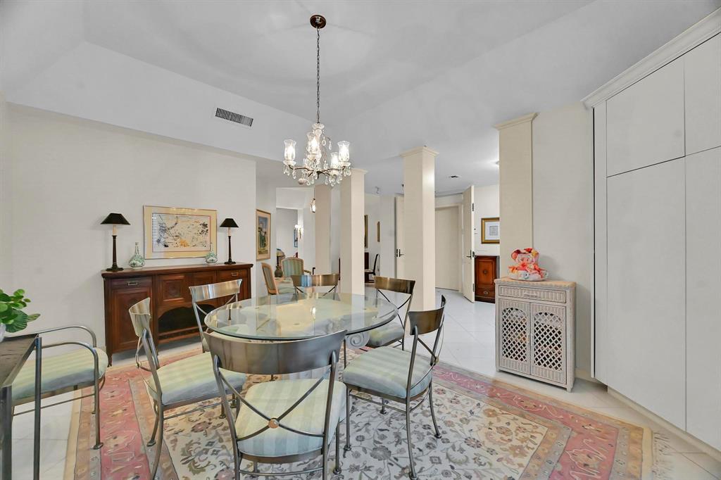 1171 North Ocean Boulevard, Unit 1A N Delray Beach, FL 33483 - Photo 13 of 41 a dining room with furniture and chandelier