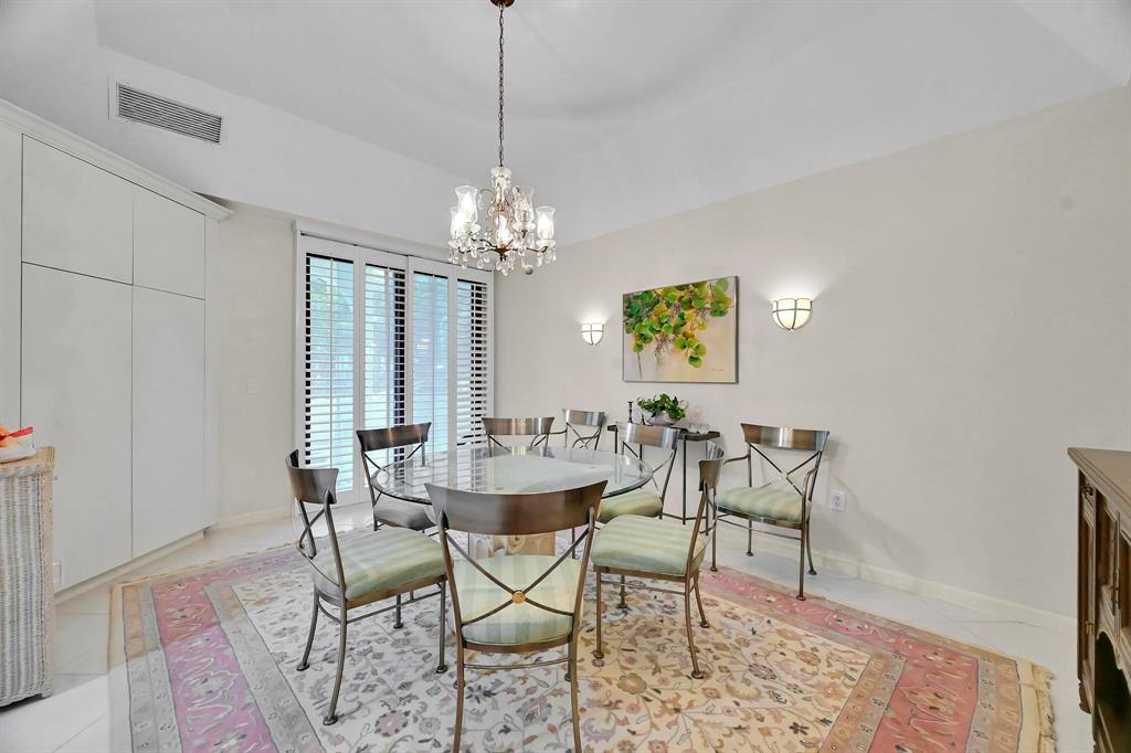 1171 North Ocean Boulevard, Unit 1A N Delray Beach, FL 33483 - Photo 14 of 41 a view of a dining room with furniture and chandelier