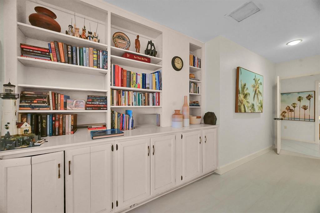 1171 North Ocean Boulevard, Unit 1A N Delray Beach, FL 33483 - Photo 15 of 41 a room with lots of books and cabinets