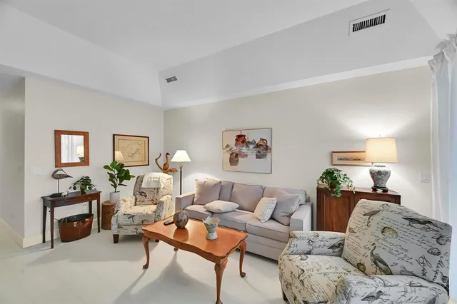 a spacious bedroom with a bed and glass windows