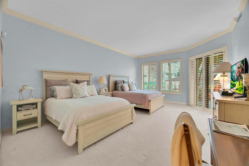 1171 North Ocean Boulevard, Unit 1A N Delray Beach, FL 33483 - Photo 18 of 41 a spacious bedroom with a bed and glass windows