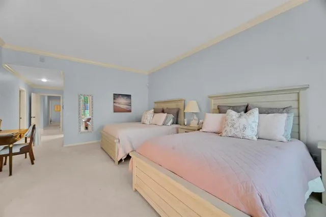 a bedroom with a large bed and a chandelier