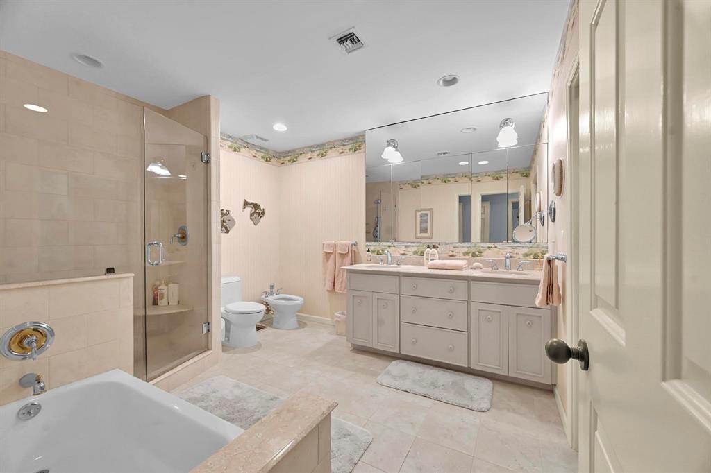 1171 North Ocean Boulevard, Unit 1A N Delray Beach, FL 33483 - Photo 21 of 41 a bathroom with a sink a toilet and shower