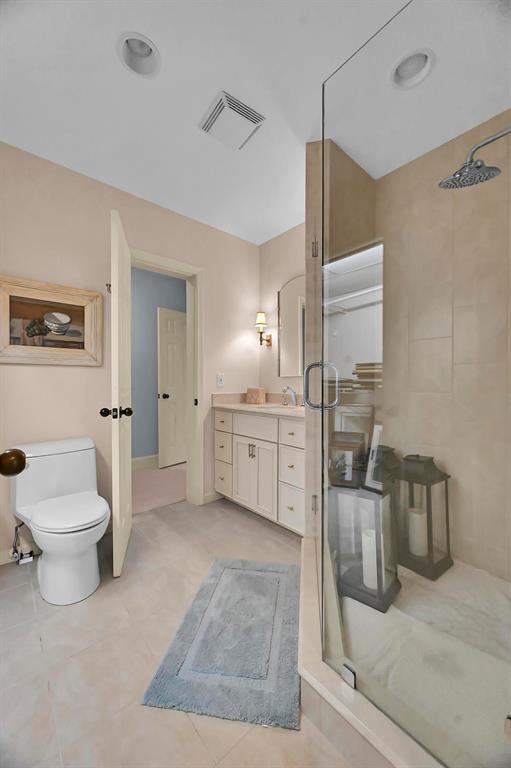 1171 North Ocean Boulevard, Unit 1A N Delray Beach, FL 33483 - Photo 24 of 41 a bathroom with a sink a toilet and shower