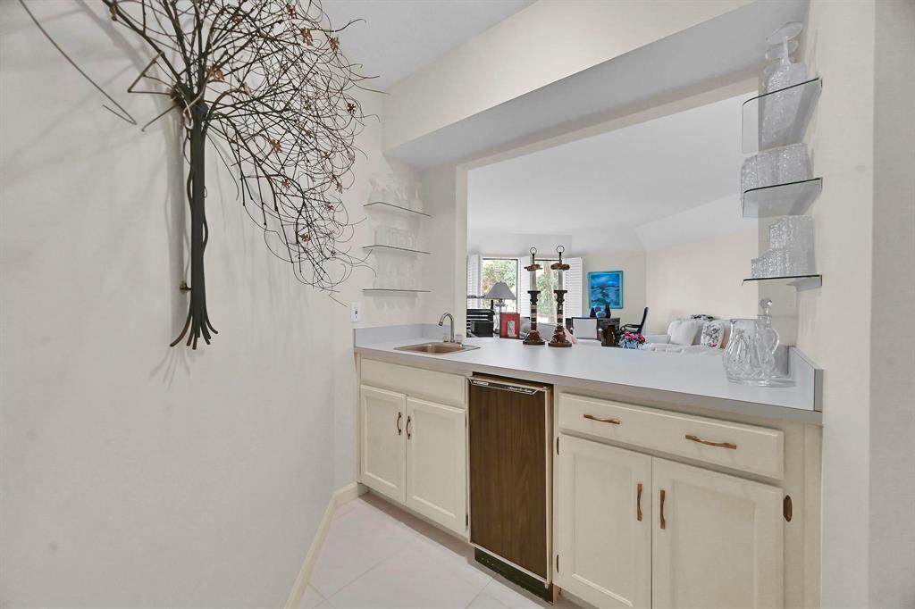 1171 North Ocean Boulevard, Unit 1A N Delray Beach, FL 33483 - Photo 34 of 41 a kitchen with a sink and cabinets