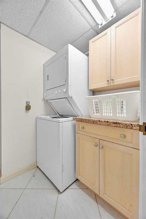 1171 North Ocean Boulevard, Unit 1A N Delray Beach, FL 33483 - Photo 36 of 41 a kitchen with granite countertop white cabinets and white appliances