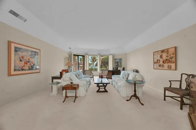 a kitchen with white cabinets stainless steel appliances and dining table
