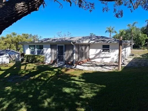 a view of a house with backyard porch and sitting area