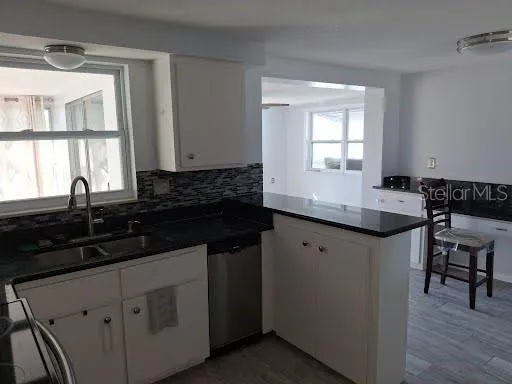 a kitchen with granite countertop a sink and a stove