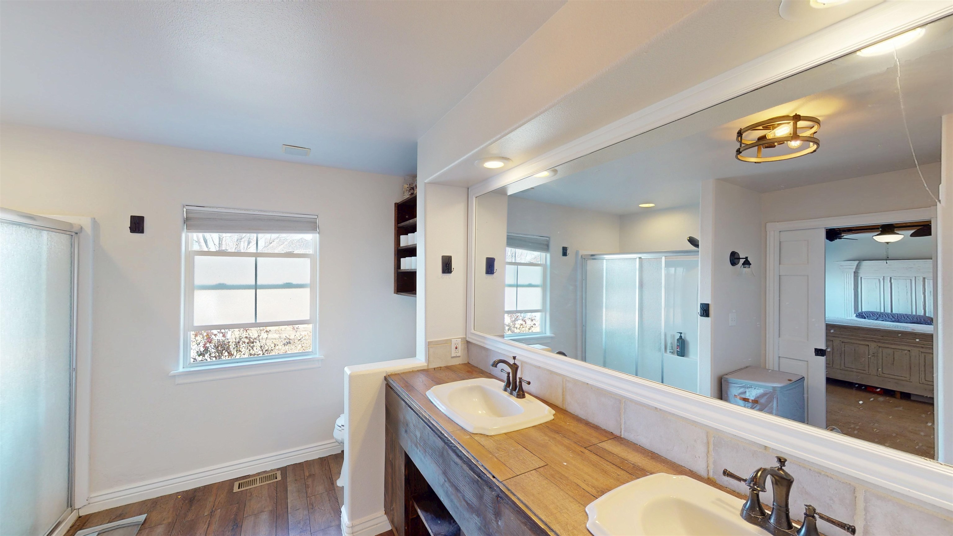 1166-17 17 1/2 Road Fruita, CO 81521 - Photo 16 of 42 a bathroom with a granite countertop sink a mirror a vanity and a shower