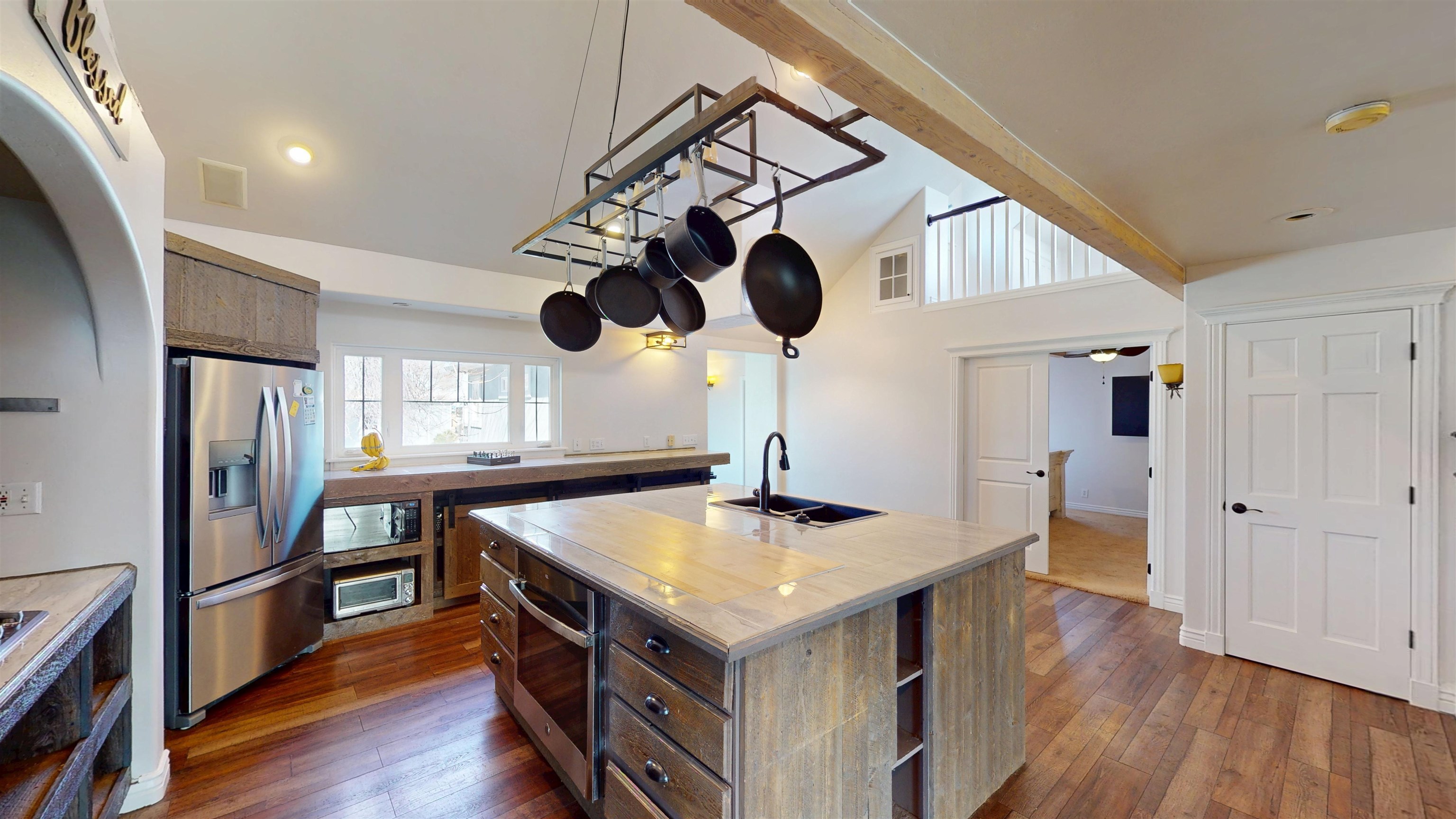 1166-17 17 1/2 Road Fruita, CO 81521 - Photo 8 of 42 a kitchen with a sink stainless steel appliances and wooden floor