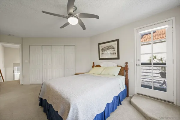 a bedroom with a large bed and a window