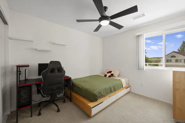 a bedroom with a bed and a window