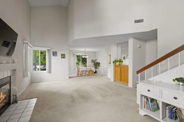 a view of an empty room with furniture and a window