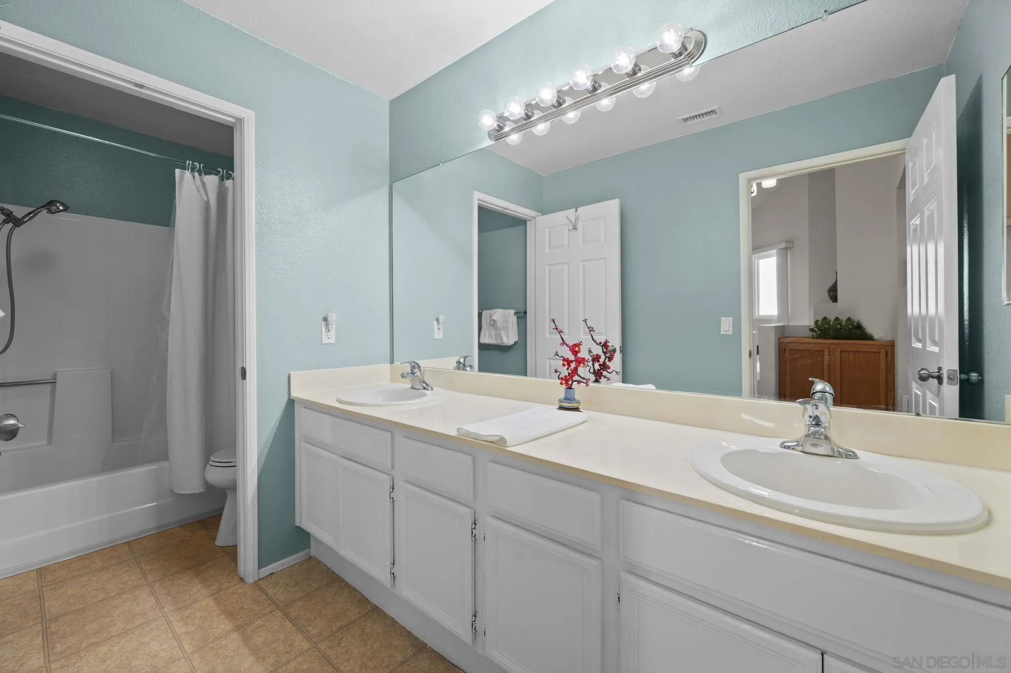 10503 Flora Azalea Court Santee, CA 92071 - Photo 21 of 33 a bathroom with double vanity and a mirror
