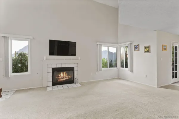 a view of a livingroom with a fireplace and window