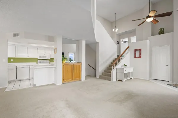 a view of a kitchen with furniture and staircase