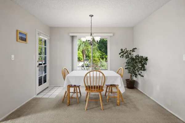 a view of a dining room with furniture window and outside view