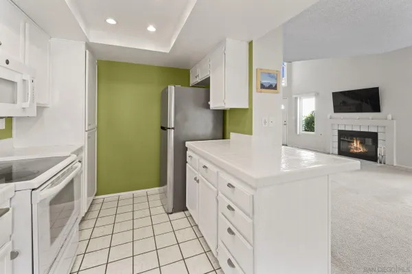 a kitchen with a sink a refrigerator and a cabinets