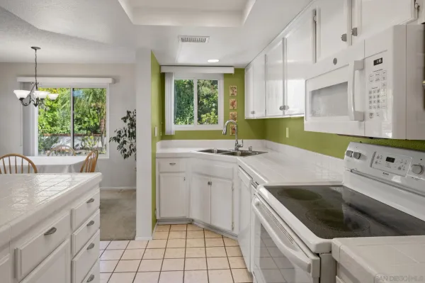 a kitchen that has a sink and a stove in it