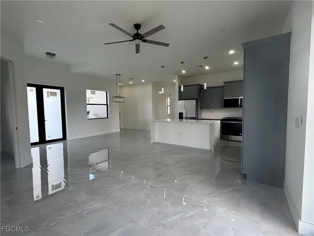 a view of a kitchen with a refrigerator and a sink