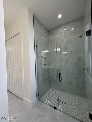 a white toilet sitting next to a white cabinet