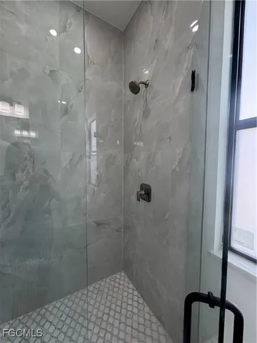 a white toilet sitting next to a white cabinet