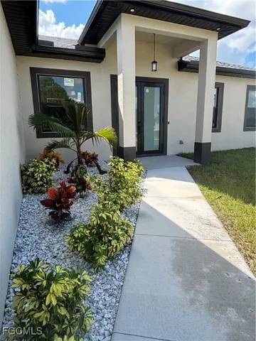 a front view of a house with lots of yellow lighting
