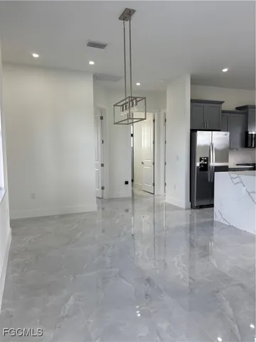a view of a kitchen with a sink and a refrigerator