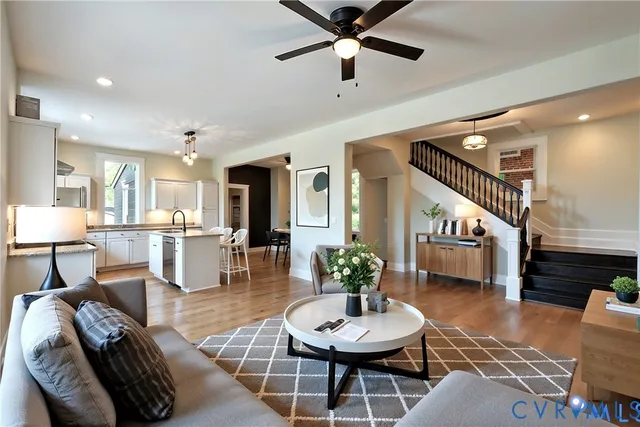 a living room with furniture and a view of kitchen