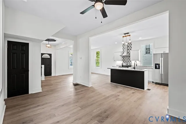 a view of kitchen with refrigerator and window