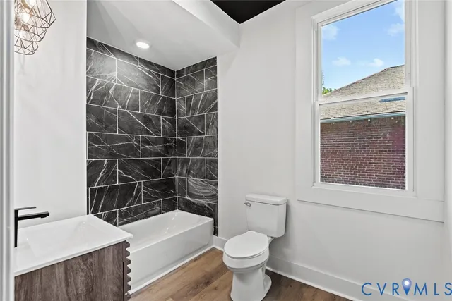 a bathroom with a toilet a sink and bathtub