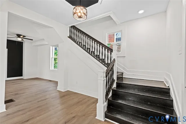 a view of entryway and hall with wooden floor