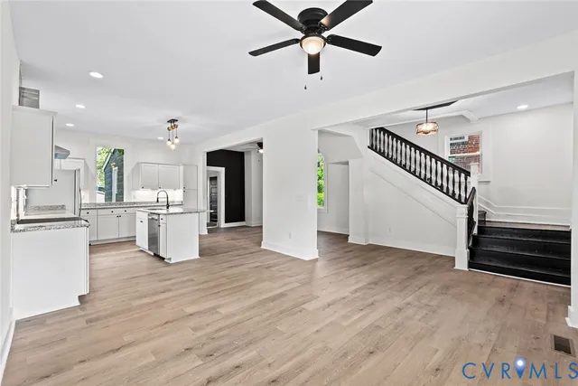 a view of a kitchen with wooden floor and electronic appliances